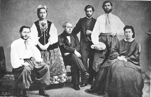 Oleksii (sitting on the left) and Khrystyna (standing next to him) Alchevsky in Ukrainian folk costu